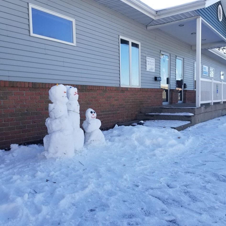 Snow people outside clinic