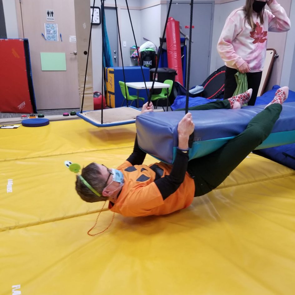 Occupational therapist guiding a core strength activity