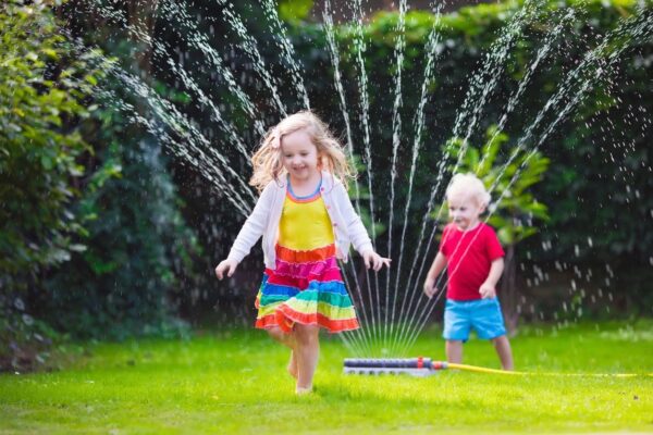 Kids running through sprinklers